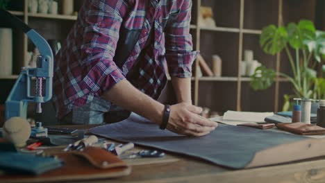 leather material quality check. craftsman inspect material quality at workshop