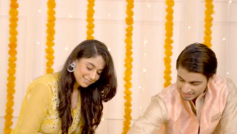 Indian-couple-making-Rangoli