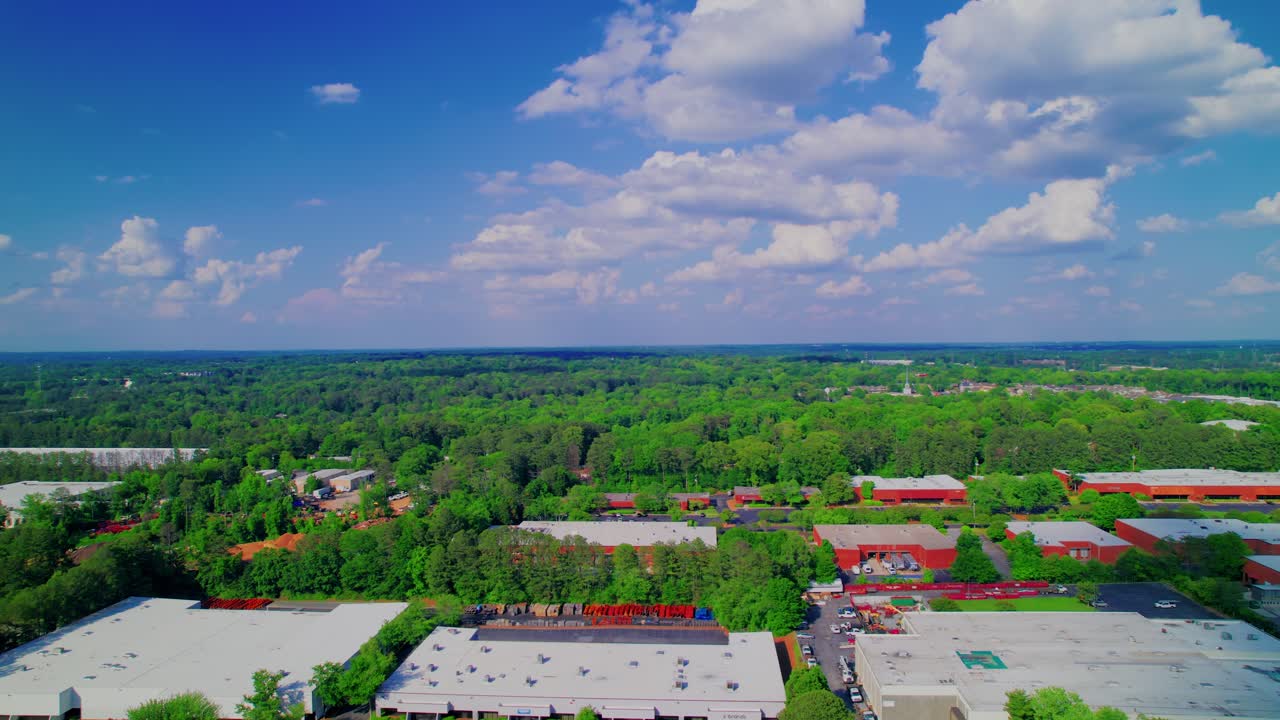 Industrial warehouses and dense suburban woodlands in Atlanta suburbs, ideal for real estate and nature projects.