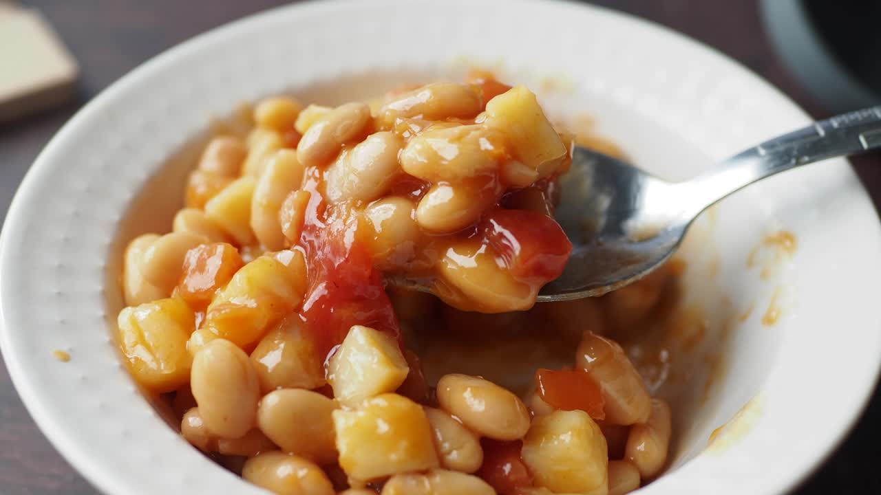 Baked beans in a bowl with a spoon