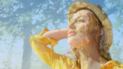 composite video of caucasian woman wearing a hat smiling against tall trees