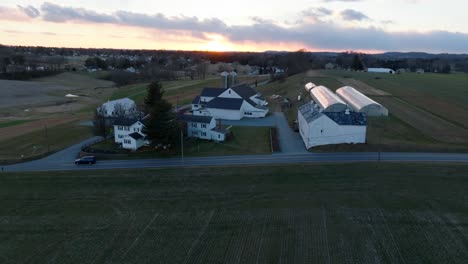aerial truck shot of american farm in winter during cold sunset