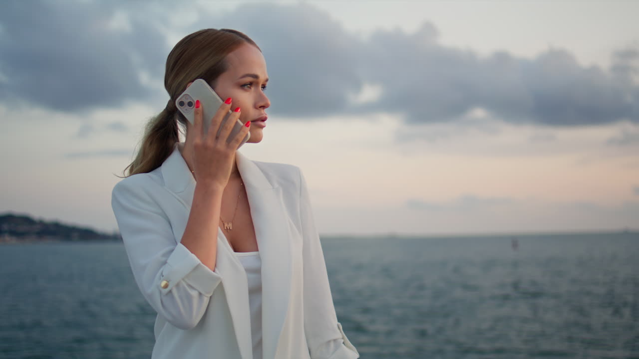 Calling woman standing sea horizon cloudy evening close up. Lady talking sunset