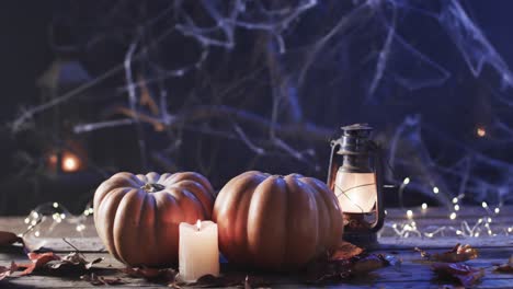 video of halloween pumpkins and candle with copy space on wooden background