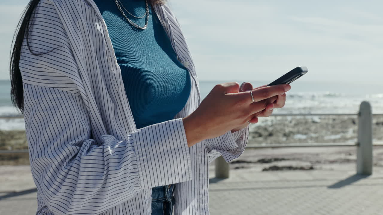 Woman using a smartphone on a beach