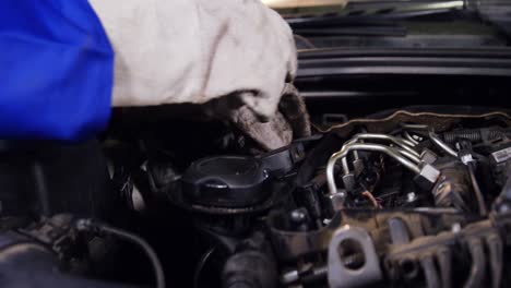 Hands-of-mechanic-checking-a-car-engine