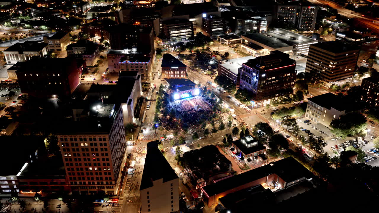 Vibrant nighttime aerial showing the glowing stage and packed audience at the Chattanooga Bluegrass Awards celebration