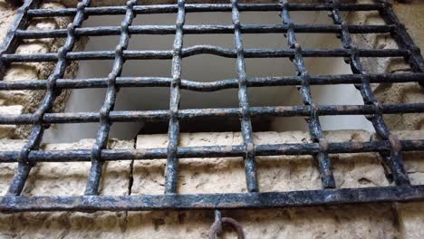 metal grid closure of a hole in ancient belem tower in lisbon, portugal