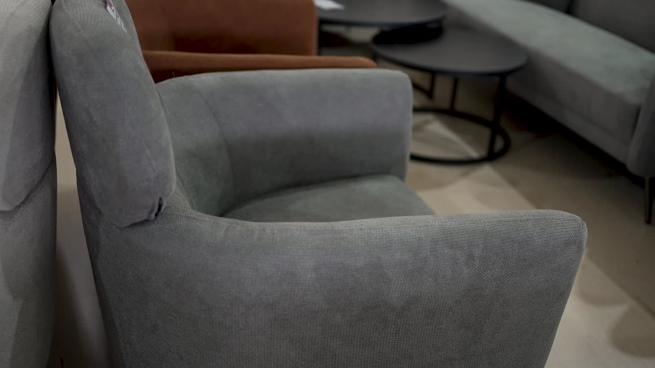 Soft, inviting chairs are arranged in a warm lounge space, providing a perfect spot for reading, chatting, or enjoying a quiet moment with a drink
