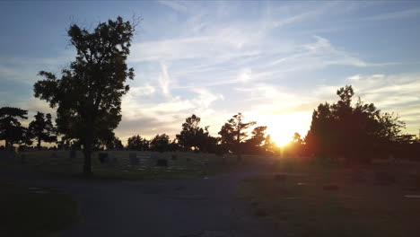 slow aerial dolly through a cemetery during sunset