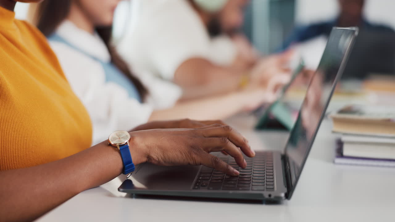 Close-up of Person's Hands Typing on Laptop Keyboard