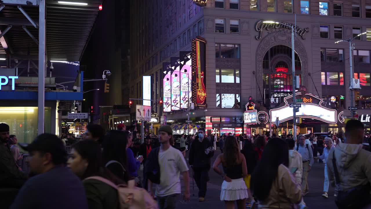 The sound of footsteps, conversations, and traffic fills the air as Times Square becomes a center of culture and commerce
