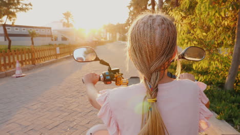 A-Niño-With-African-Pigtails-Riding-A-Scooter-Rear-View-Cheerful-And-Active-Recreation