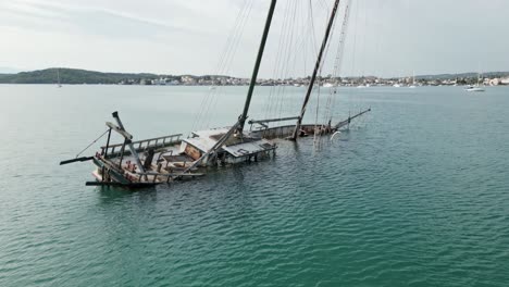 submerged desolate sailing ship wreck in quiet greek bay of mediterranean sea