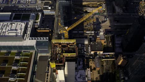 aerial view of a crane and a skyscraper construction site in hudson yards, ny- high angle, tracking, drone shot