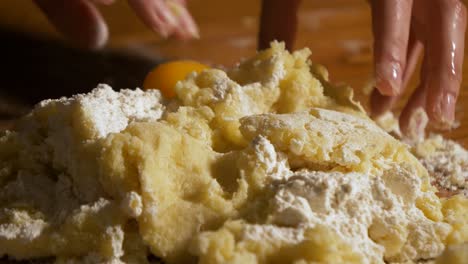 4k close up slow motion shot cracked white egg dropped into a heap of mashed potatoes and flour