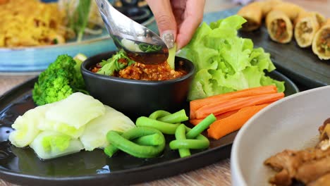 preparing a spicy chili dip for vegetables