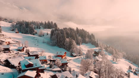 Stunning-drone-footage-of-Wengen,-Switzerland-nestled-in-snow-capped-Swiss-Alps