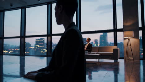 business professionals working in modern office with city views