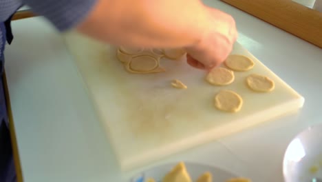 cutting flattened dough into circles with a round mould - close up