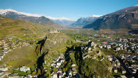 a vista of valere basilica and tourbillon castle during autumn in sion, valais switzerland