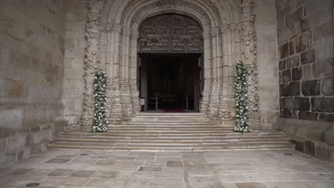 elegant wedding entrance with floral decor at a historic church doorway