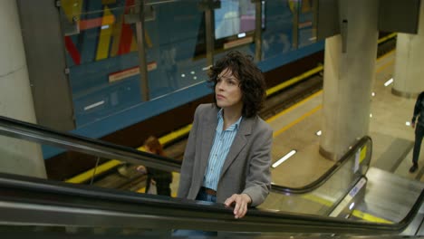 woman on an escalator in a metro station