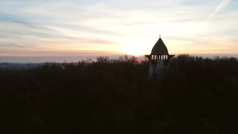 Aerial-Zoom-Out-Of-A-Viewpoint-On-A-Hill-With-Sunrise-in-The-Background