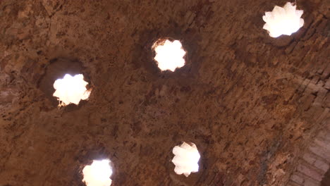 4k-rotating-down-up-view-of-Arabic-baths-ceiling-in-Ronda,-Malaga,-Spain,-historic-Arabic-culture-ruins-in-Spain