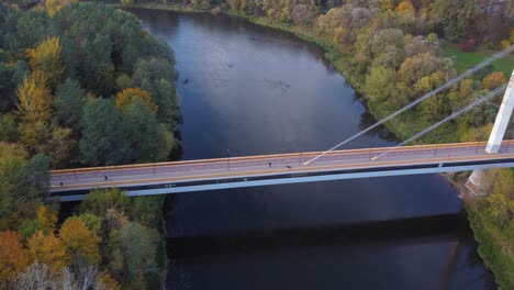 AERIAL-Fly-By-of-a-Bridge-with-Cyclists-and-Pedestrians-in-Vilnius,-Lithuania-during-Autumn
