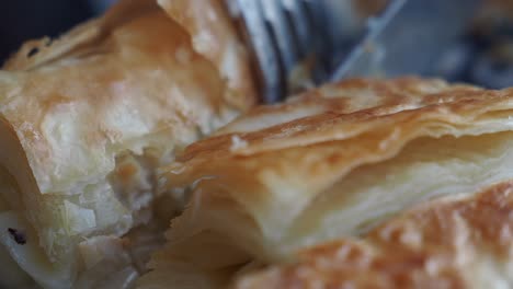 close-up of flaky pastry with cheese filling