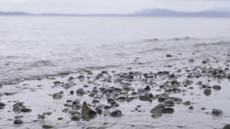 Slow-motion-footage-of-peaceful-ocean-waves-rolling-over-a-rocky-ocean-shoreline-in-Victoria-Canada