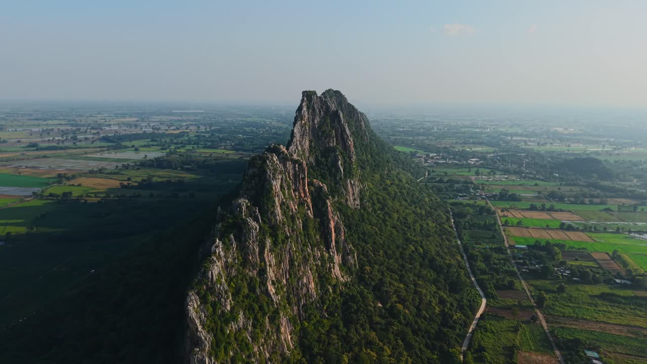 Aerial View of a Mountain Range with Lush Forest and Farmlands