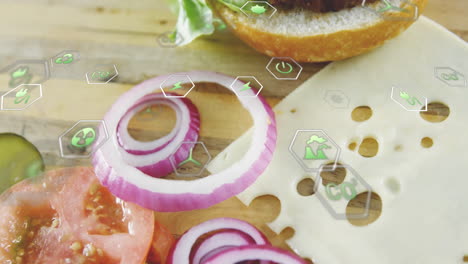 digital icons overlay on sliced vegetables and cheese on wooden board