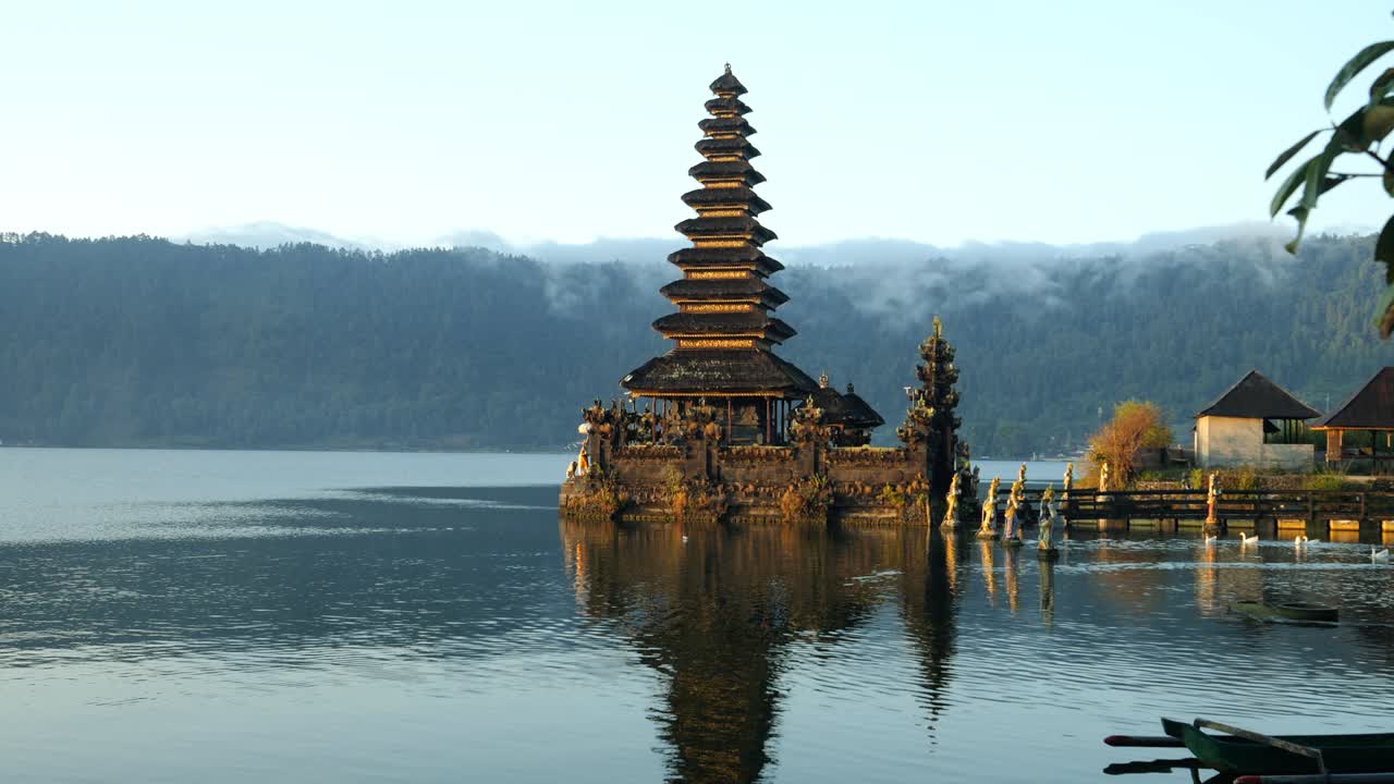 slow motion ascending shot of the Pura Segara Ulun Danu Batur on the summer trip through bali indonesia at the volcanic lake Batur during a sunny morning