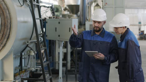 busy factory workers with tablet