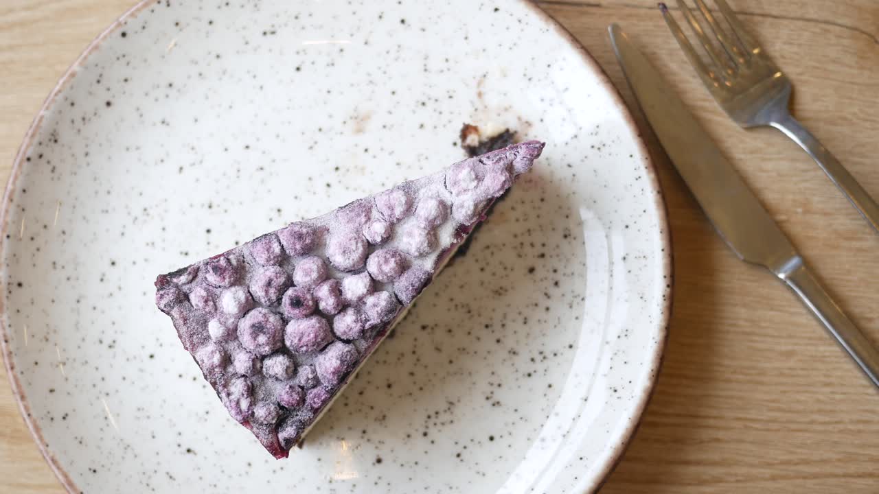 A slice of blueberry cheesecake on a plate