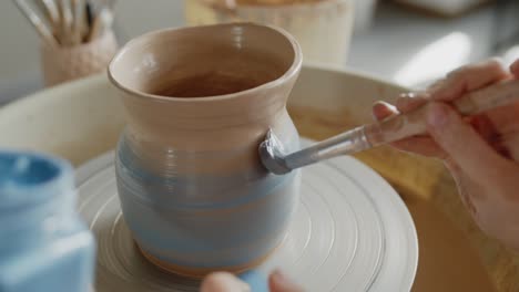 grandmother teaches her granddaughter working on a pottery rotating wheel