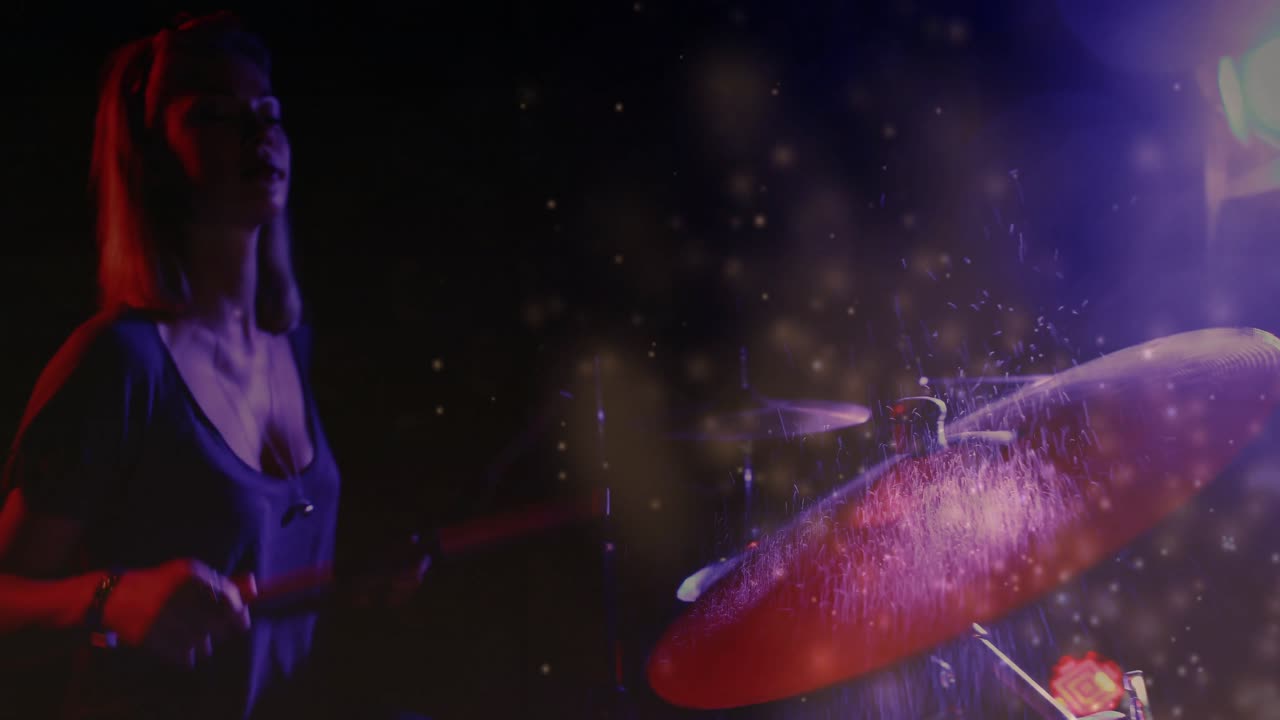 Female drummer raising sticks and striking snare amid purple lights scattering haze showing rhythm