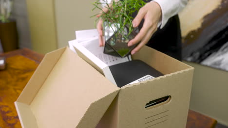 Close-Up-Of-An-Unrecognizable-Female-Employee-Packing-Office-Stuff-After-Resignation