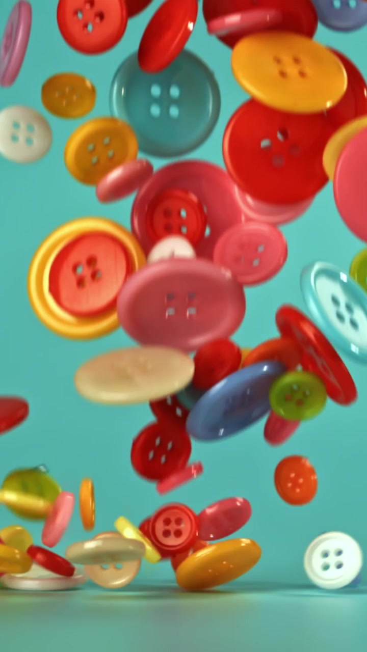 Colorful Sewing Buttons Falling and Bouncing in Slow Motion