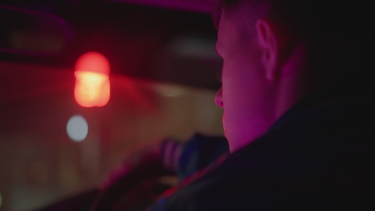 red light car driver smoking exhale under neon, smoke curling through dashboard glow, close profile at intersection, waiting at signal, anxious stillness, handheld cinematic feel, scenes suggest cab