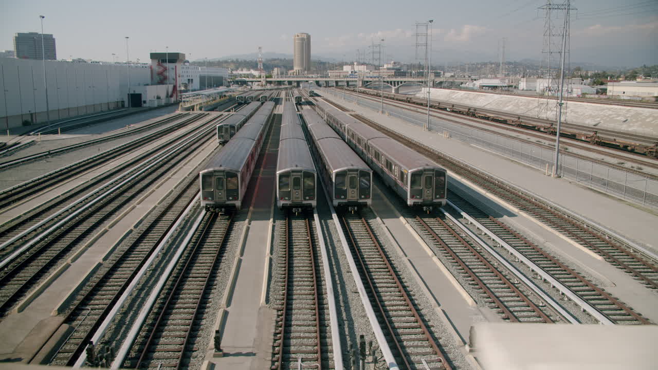 Multiple trains parked on tracks in an urban train yard