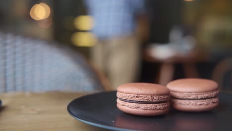 chocolate macarons on a plate in a cafe