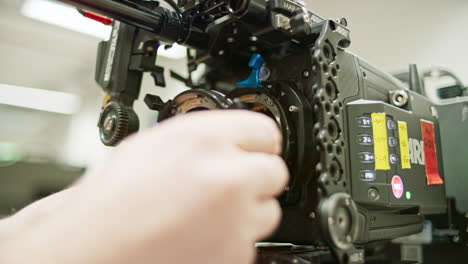 the body cap of a high end professional cinema camera is removed from the large format lpl mount, lpl to pl adapter is inserted and a super35 lens is mounted on the camera