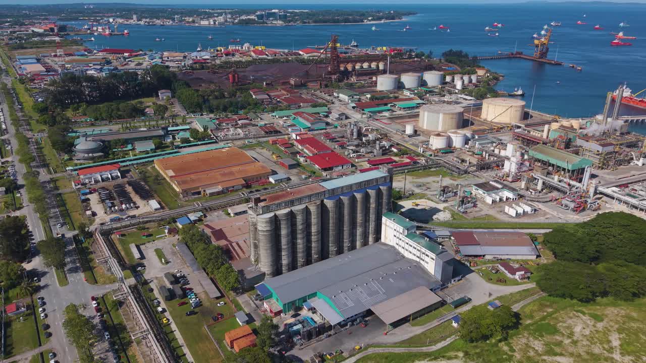 Drone view of Labuan's Rancha-Rancha Industrial Estate, Malaysia. The shot captures cement storage silos