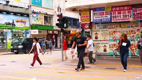 pedestrians crossing a bustling city intersection