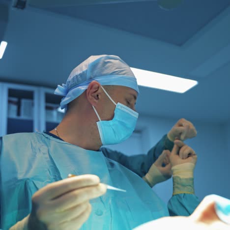 plastic surgery. male doctor together with a nurse performing a blepharoplasty on a woman's face. medical procedure for facial correction.
