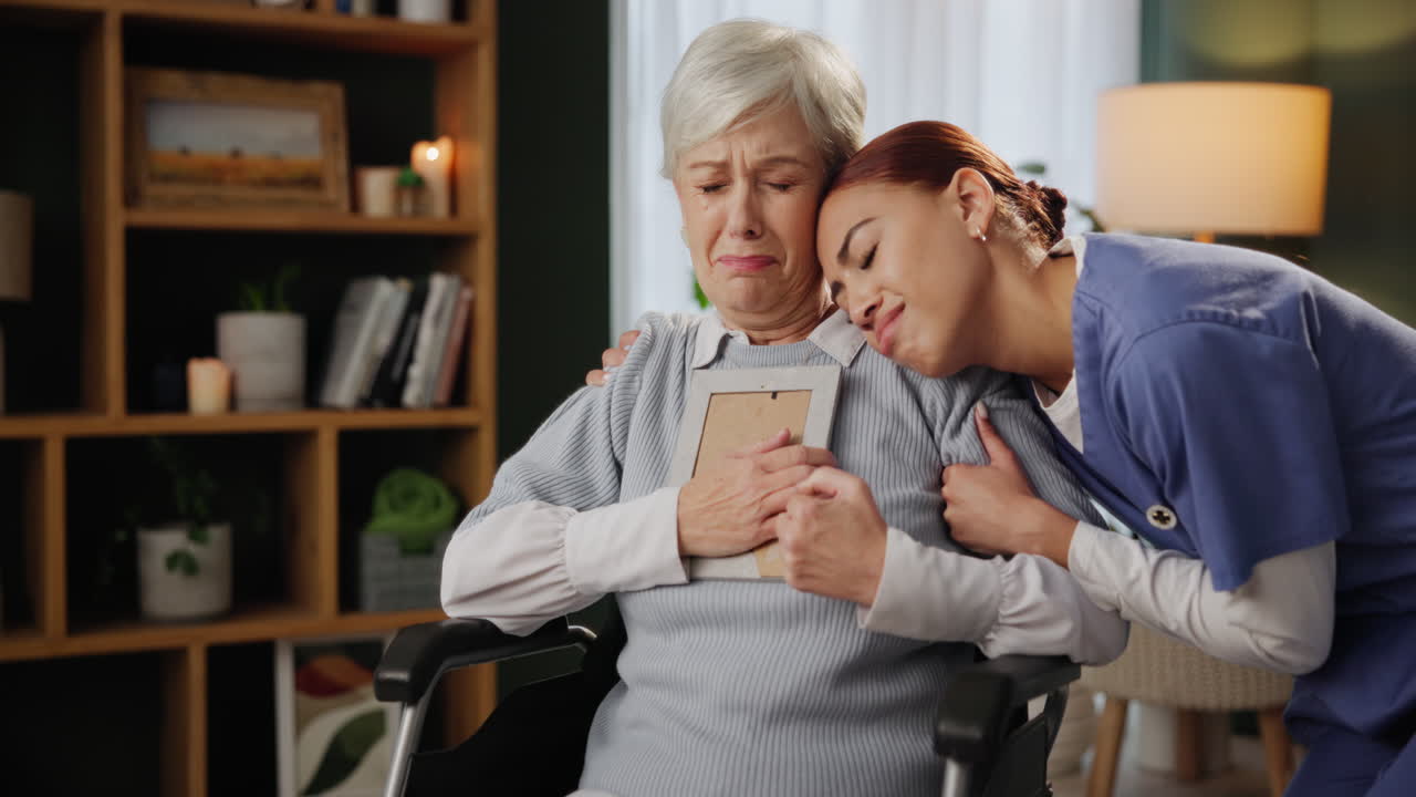 Comforting caretaker supporting a grieving senior woman
