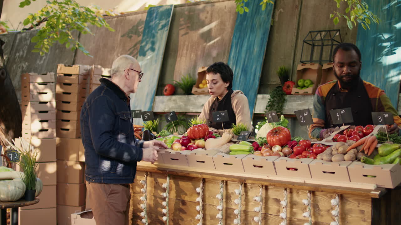 Customer buys produce from a fruit stand